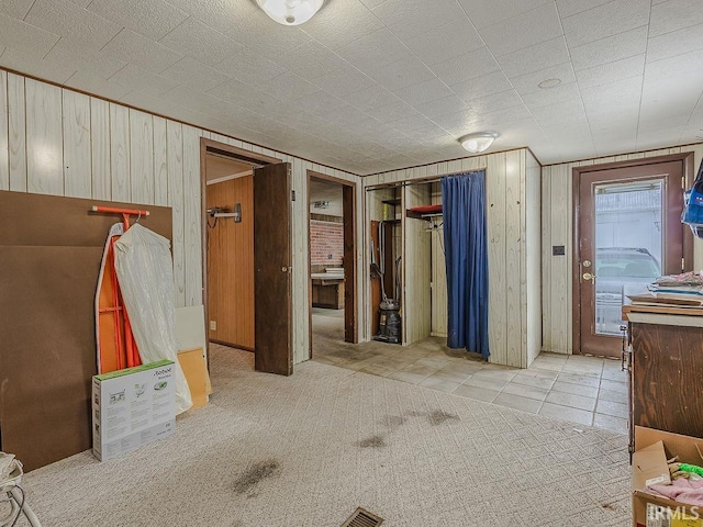 unfurnished bedroom with wooden walls