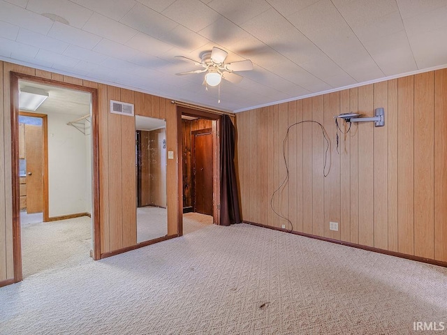 unfurnished bedroom featuring ceiling fan and light colored carpet