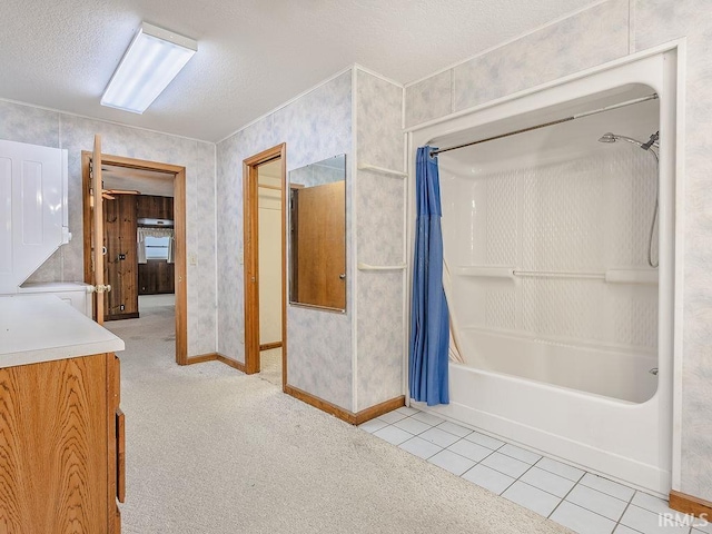 bathroom featuring shower / tub combo with curtain, vanity, a textured ceiling, and tile patterned flooring