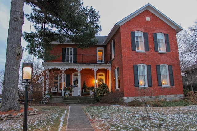 view of front of property featuring a balcony and a porch