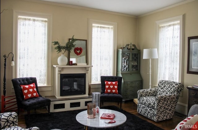 living area with ornamental molding and dark wood-type flooring