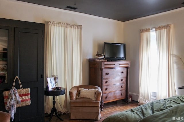 sitting room featuring hardwood / wood-style floors and crown molding