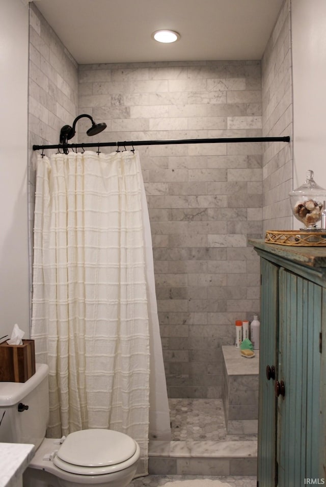 bathroom with a shower with curtain and toilet