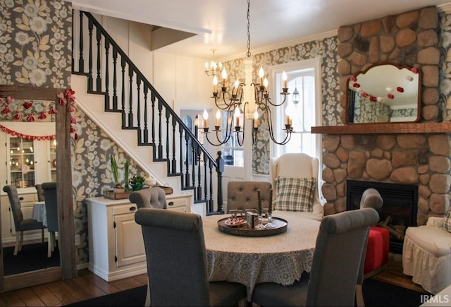 dining space featuring a fireplace, dark hardwood / wood-style flooring, and crown molding