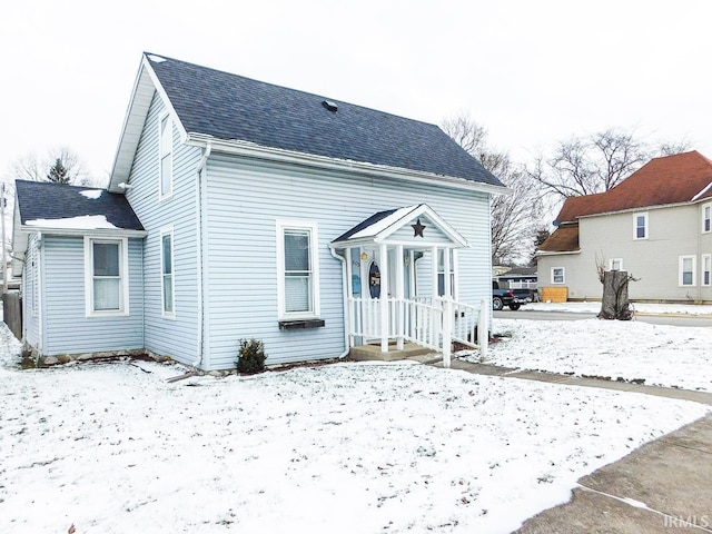 view of snow covered back of property