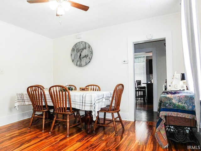 dining space with hardwood / wood-style floors, ceiling fan, and ornamental molding