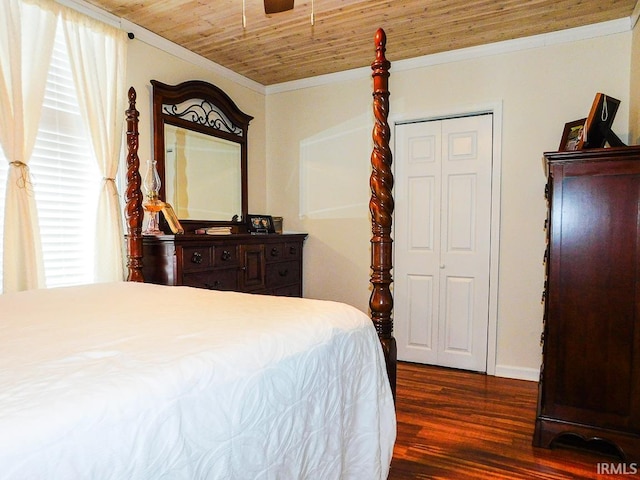 bedroom with dark wood-type flooring, crown molding, a closet, and wooden ceiling