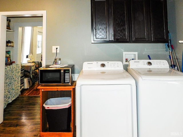 washroom with cabinets, dark wood-type flooring, and washer and dryer