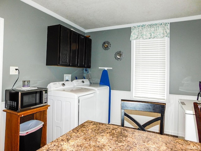 washroom featuring crown molding and washer and dryer