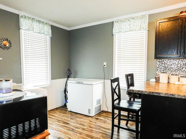 interior space with crown molding and light wood-type flooring