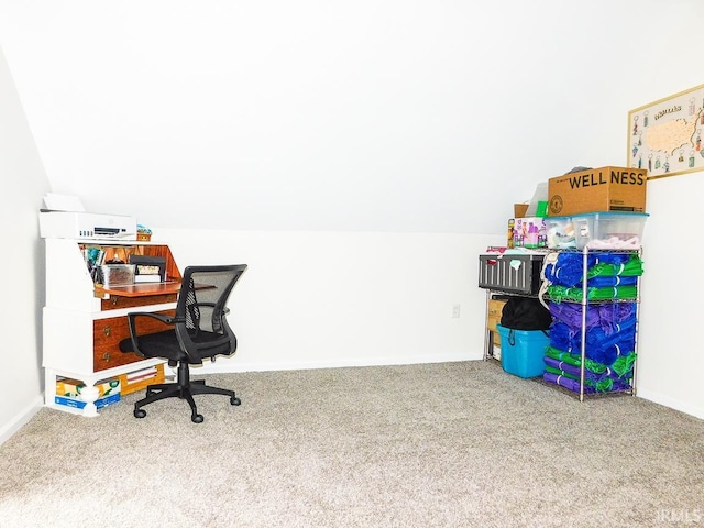 carpeted office with vaulted ceiling