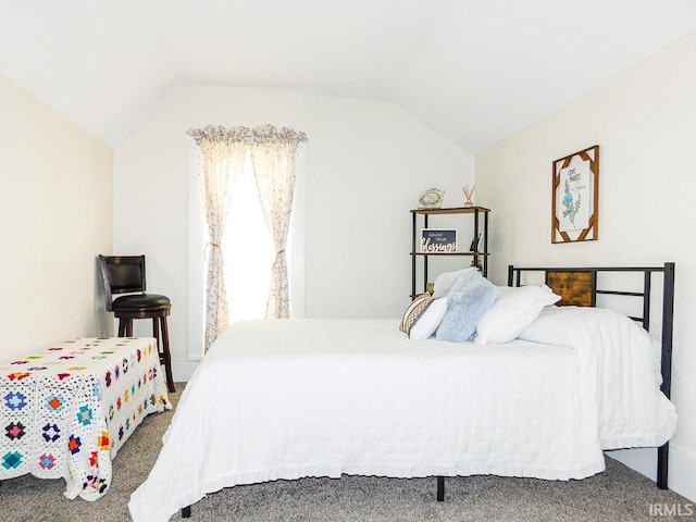 bedroom featuring carpet floors and lofted ceiling