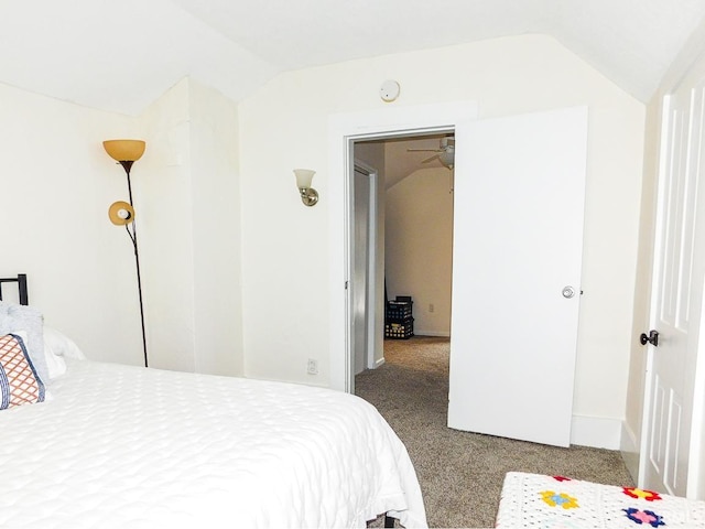 carpeted bedroom featuring vaulted ceiling