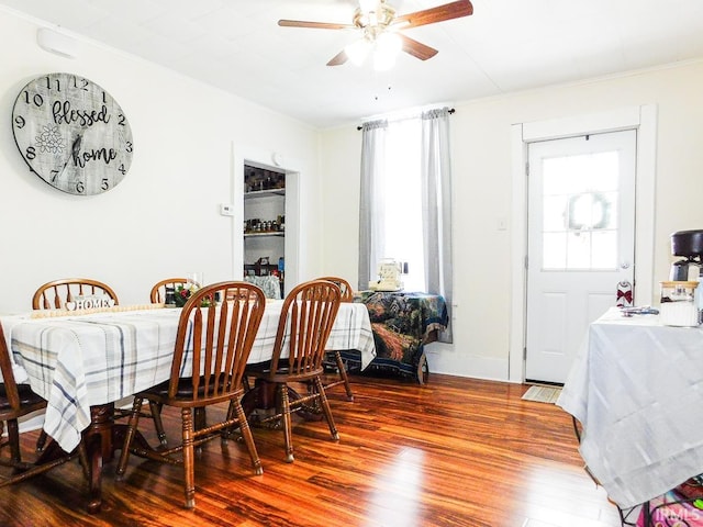 dining space featuring wood-type flooring and ceiling fan