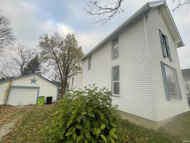 view of side of home featuring an outdoor structure and a garage