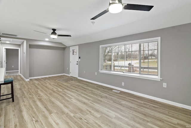 unfurnished living room featuring light hardwood / wood-style flooring and vaulted ceiling