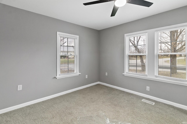 carpeted spare room with ceiling fan