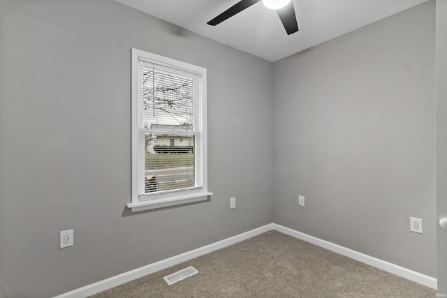 carpeted spare room featuring ceiling fan