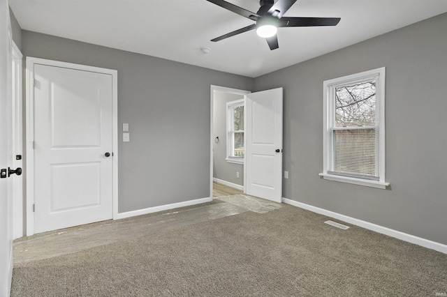 unfurnished room featuring carpet floors and ceiling fan