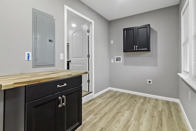 laundry room featuring cabinets, washer hookup, hookup for an electric dryer, electric panel, and light wood-type flooring