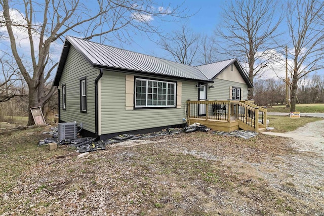 view of front facade featuring central AC and a wooden deck