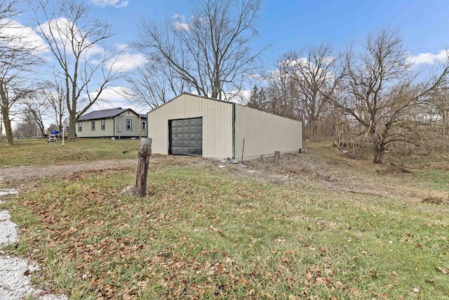 view of outbuilding with a garage and a yard