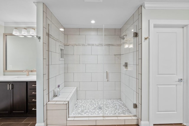 bathroom featuring vanity, crown molding, and walk in shower