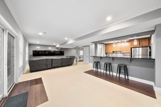 living room featuring light carpet and ornamental molding