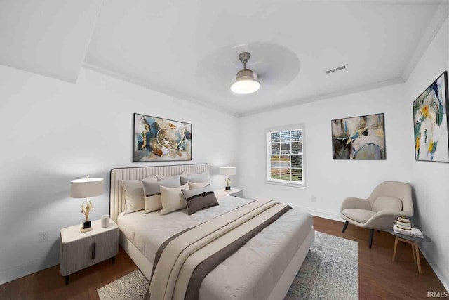 bedroom with ceiling fan, crown molding, and dark hardwood / wood-style floors