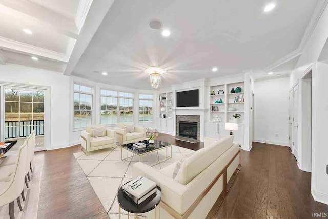 living room featuring built in shelves, hardwood / wood-style floors, beamed ceiling, and ornamental molding