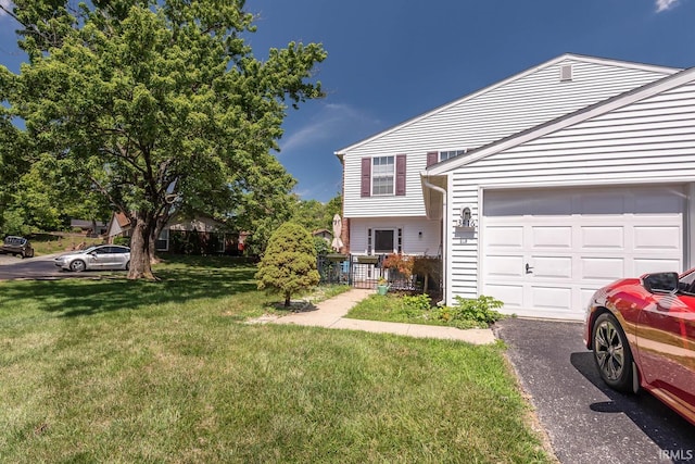 view of front of property with a garage and a front lawn