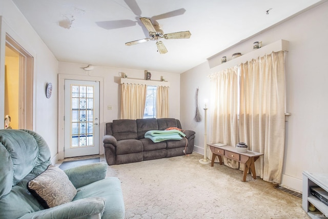 living room with light carpet and ceiling fan