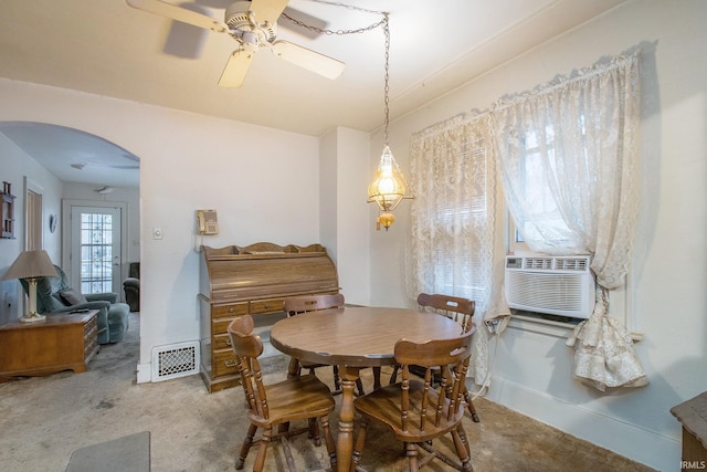 carpeted dining room with ceiling fan