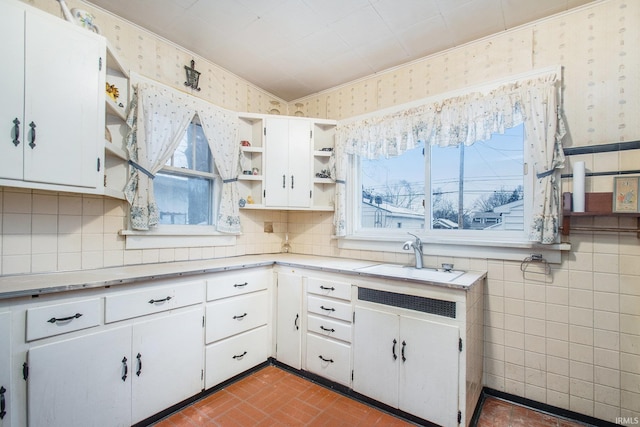 kitchen featuring white cabinets and sink