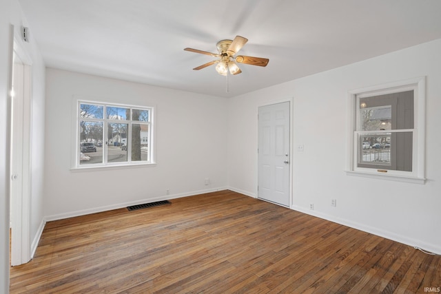 spare room featuring hardwood / wood-style floors and ceiling fan