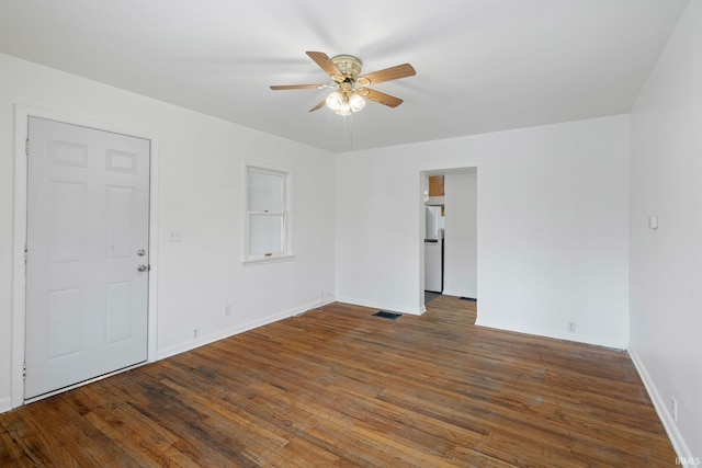 unfurnished room featuring ceiling fan and dark wood-type flooring