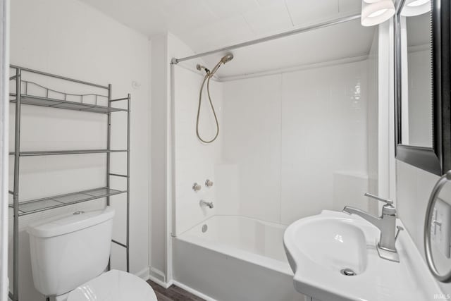 full bathroom with hardwood / wood-style floors,  shower combination, toilet, and sink