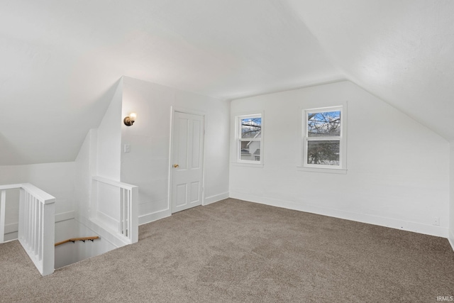 additional living space with carpet and lofted ceiling