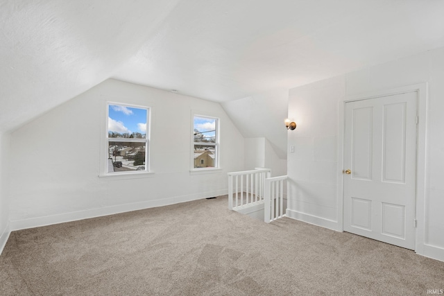 additional living space with carpet and lofted ceiling