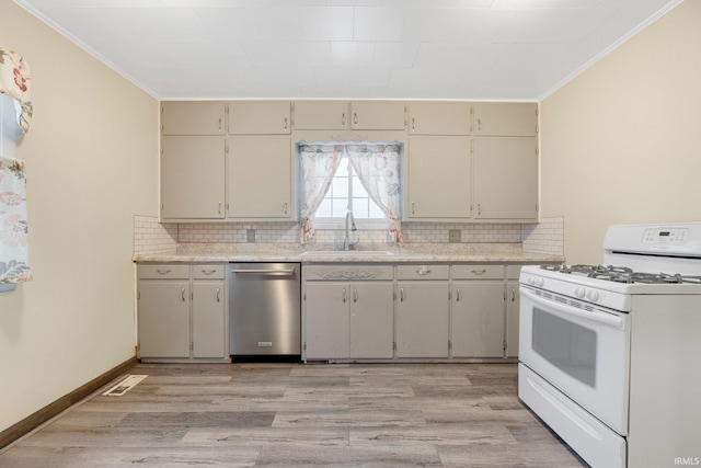 kitchen with dishwasher, light wood-type flooring, white gas stove, and sink