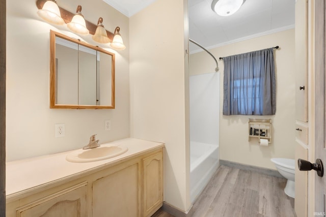 full bathroom featuring vanity, shower / washtub combination, crown molding, hardwood / wood-style floors, and toilet