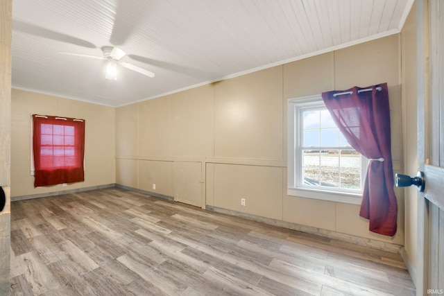 empty room featuring ceiling fan, light hardwood / wood-style floors, and crown molding