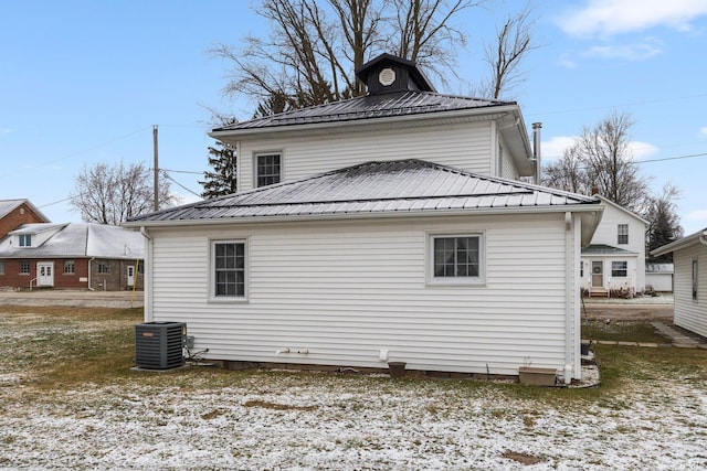 rear view of house featuring central air condition unit