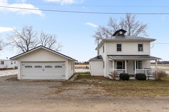 view of front facade with a garage, covered porch, and an outdoor structure