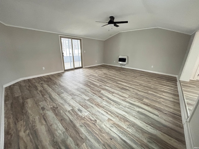 unfurnished room with heating unit, crown molding, wood-type flooring, and vaulted ceiling