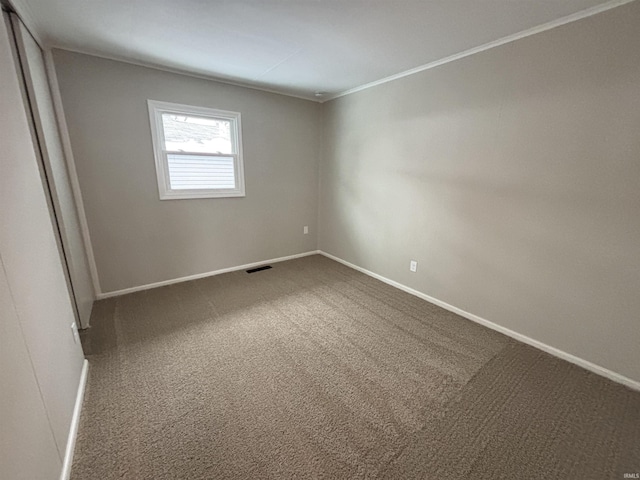 carpeted empty room with crown molding