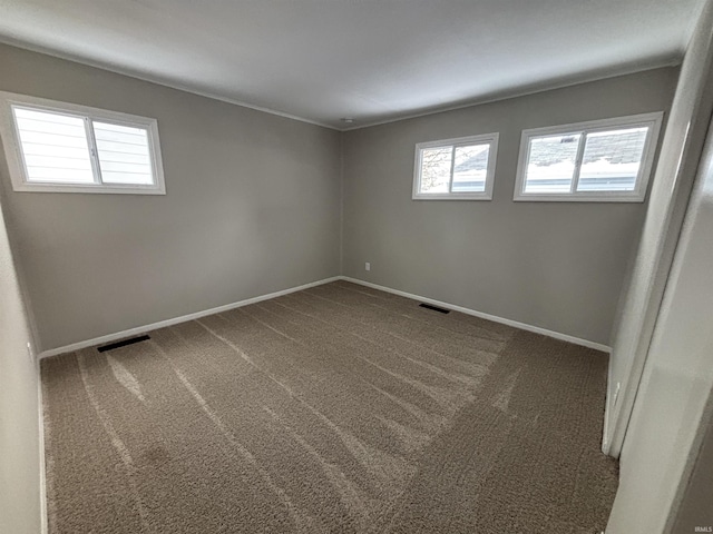 spare room with dark carpet