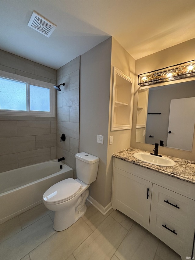 full bathroom with tile patterned floors, tiled shower / bath combo, toilet, and vanity