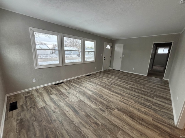 interior space with dark hardwood / wood-style floors and a textured ceiling