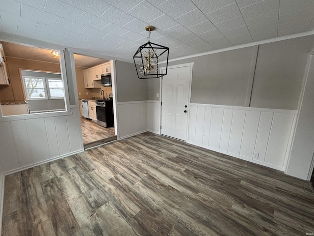 unfurnished dining area featuring hardwood / wood-style floors and ornamental molding